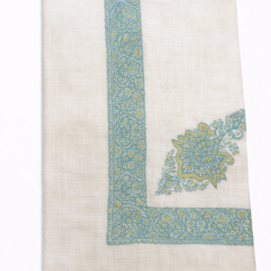 ivory base with turquoise and pale yellow embroidery.